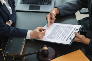 Lawyer reviewing and explaining contract agreement to client in legal office.