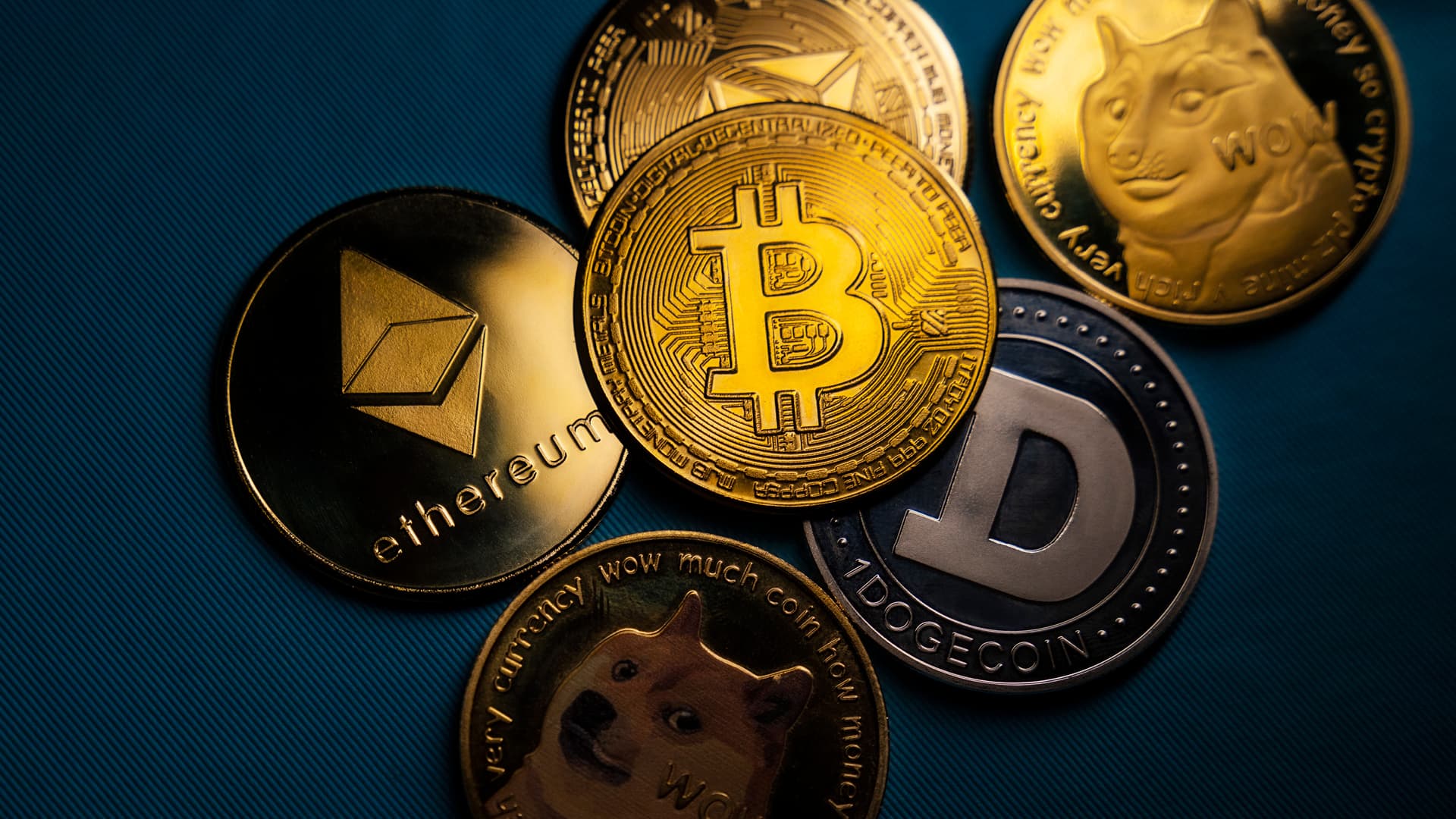 Assorted cryptocurrency coins including Bitcoin, Ethereum, and Dogecoin, representing the complexity of managing and valuing digital assets in California trust disputes.