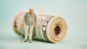 elderly figure with roll of money, financial elder abuse